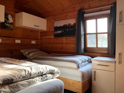 a room with four beds in a log cabin at Marlies - Lastering Ferienhäuser & Apartments in Wettringen