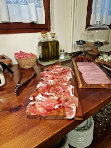 a cutting board with meat on top of a counter at Hostal Remoña in Espinama