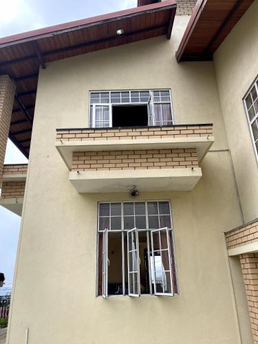 a building with two windows and a balcony at The Vatican Villa in Nuwara Eliya