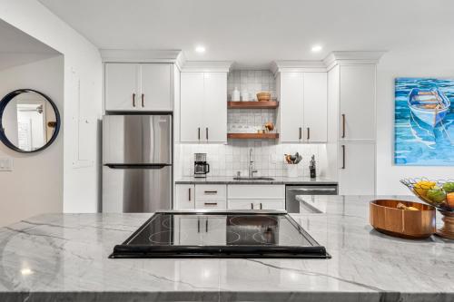 a kitchen with white cabinets and a counter top at 4821 Turtle Cove Villa by Akers Ellis Rentals in Kiawah Island