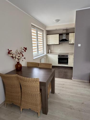a kitchen and dining room with a table and chairs at Apartament Rodzinny Zielone Tarasy in Skorka