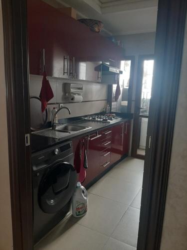 a small kitchen with a sink and a stove at Chambre d'hôte jardins de Hamria in Meknès