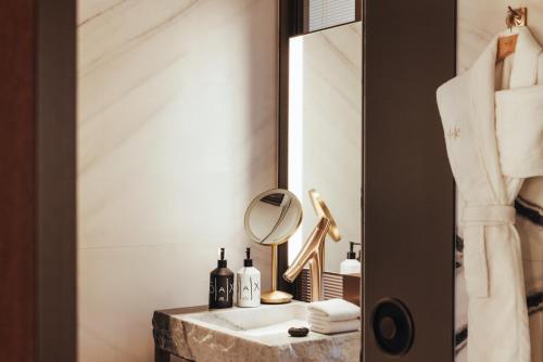 a bathroom with a sink and a mirror at Hotel SAX Paris, LXR Hotels & Resorts in Paris