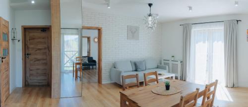 a living room with a table and a couch at Willa Malinka Wisła in Wisła