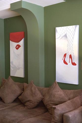a room with two paintings on the wall and a couch at Park 12 in Kavaklıdere