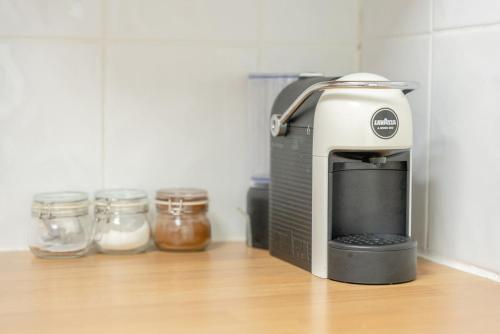 a toaster sitting on a kitchen counter next to jars at Todd Crag - Amazing Views in Ambleside