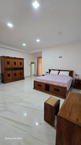 a bedroom with two beds and a table at Kingston Estate in Digana