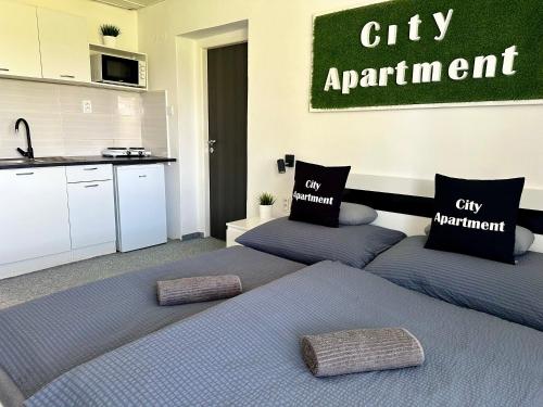a bedroom with two beds and a city apartment at City Apartment in Štúrovo