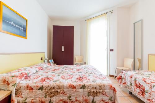 Postel nebo postele na pokoji v ubytování Villaggio Le Acacie