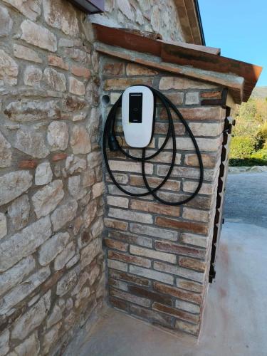 a brick wall with a soap dispenser on it at La Bottega di Torreluca in Todi