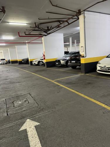 a parking garage with cars parked in it at Ondina Apart Hotel 02 quartos Vista Mar in Salvador