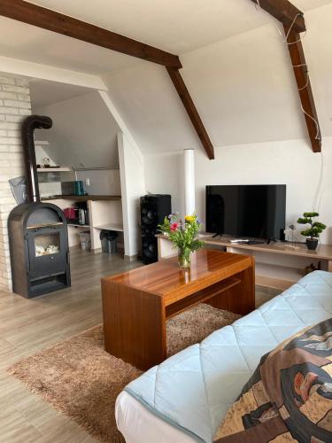 a living room with a couch and a wood stove at Chata u Jančúra in Vinné