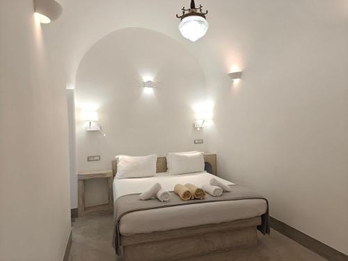 a bedroom with a bed with two stuffed animals on it at Dreamer's secret villa II in Emporio Santorini