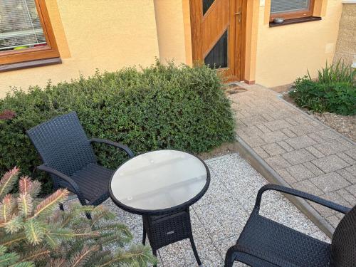 a patio with two chairs and a table and a table at Apartmán Slivková in Trenčín