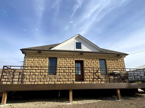 a brick house with a roof on top of it at Canyon Acres Ranch in Russell
