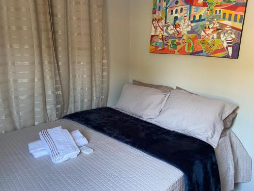 a small bed with towels on it in a room at Ville Acqua Park in Bragança