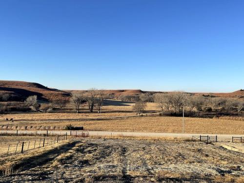 a dirt road in the middle of a field at Canyon Acres Ranch in Russell