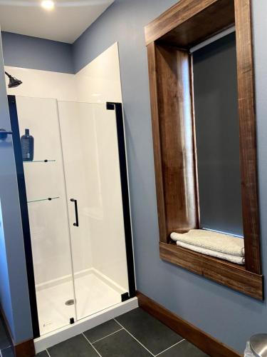 a bathroom with a shower and a mirror at Canyon Acres Ranch in Russell