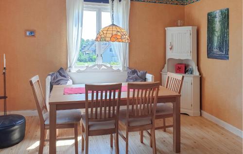 a dining room with a table and chairs and a window at Pet Friendly Home In Ruda With Sauna in Ruda