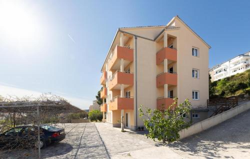 a building with a car parked in front of it at Stunning Apartment In Duce With Sea View in Duće