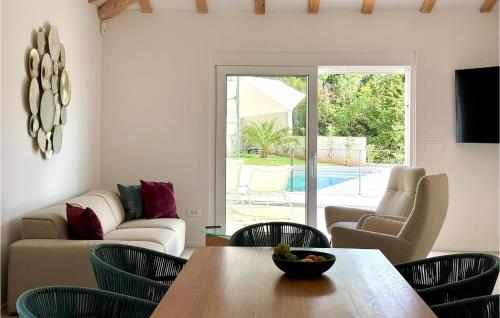 a living room with a table and chairs at Gorgeous Home In Dobrec With Sauna in Dobreć
