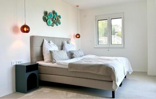 a white bedroom with a bed with a window at Gorgeous Home In Dobrec With Sauna in Dobreć