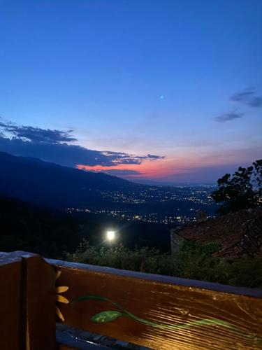 a view of a city at night from a bench at Maira House in Platamonas