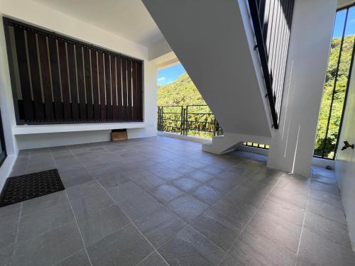 an empty living room with a large window and tile floor at Dawn Valley in Green Island