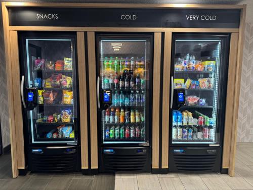 two refrigerators in a store with drinks and sodas at Days Inn & Suites by Wyndham Wausau in Wausau