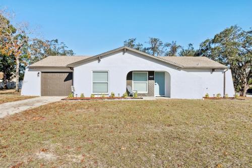 a white house with a yard at Luxury getaway, relax, and recharge! in Spring Hill