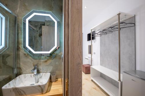 a bathroom with a sink and a mirror at Vila Ali in Sarandë