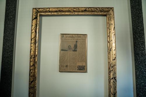 a picture of a newspaper on a wall at Hotel Marabella in Sibiu