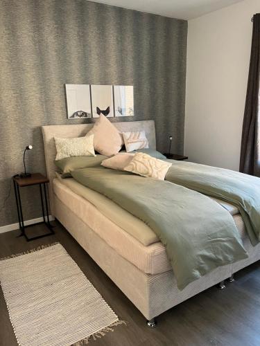 a bedroom with a large bed with pillows on it at Quartier Lookvenne Wohnung 4 in Emden