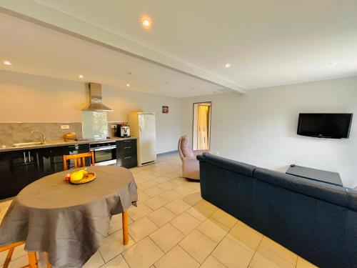 a living room with a couch and a table at PierrAnge in Grillon