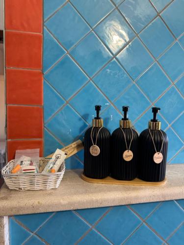 two black bottles on a shelf in a bathroom at Il Gallo di Gallura in Tempio Pausania