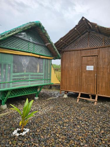 a couple of huts sitting next to each other at Balay Sa Uma in Iloilo City
