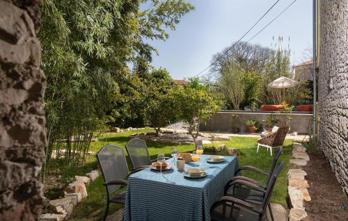 a table with a blue table cloth on a yard at Amazing Home In Pula With Sauna in Pula