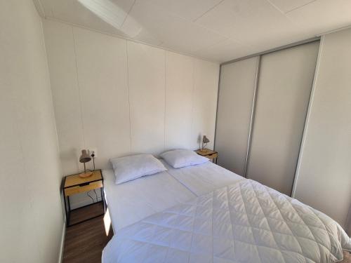 a bedroom with a large bed with two pillows at Eldorado in Petten