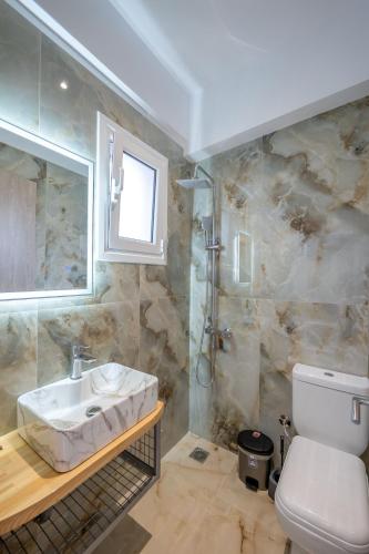 a bathroom with a sink and a toilet at Vila Ali in Sarandë