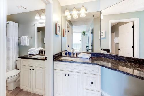 a bathroom with a sink and a large mirror at The Beach Club 507C in Gulf Highlands