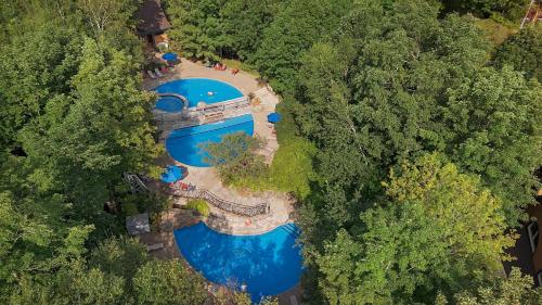 an overhead view of two swimming pools in a forest at Tremblant Prestige - Manoir 108-2 in Mont-Tremblant