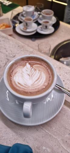 a cup of coffee on a plate on a table at Il Gallo di Gallura in Tempio Pausania