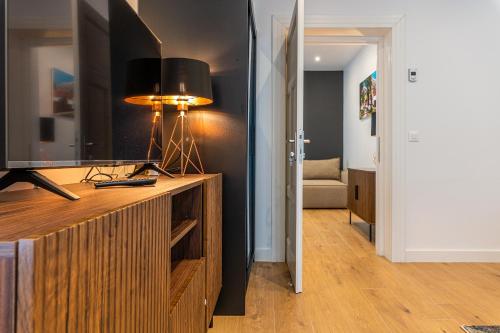 a living room with a television on a wooden entertainment center at Pensiunea Casa Weiss in Rimetea