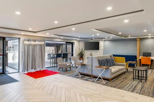 a lobby with a couch and chairs and a table at Holiday Inn Express Chicago-Downers Grove by IHG in Downers Grove