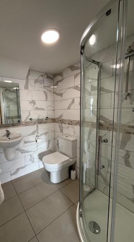 a bathroom with a toilet and a glass shower at SEASIDE HOUSE 12 Shore Street, Avoch IV9 8QD in Avoch