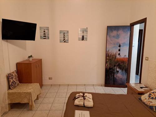 a living room with a tv and a couch at Holidays at the Dock - Fiumicino Airport in Fiumicino