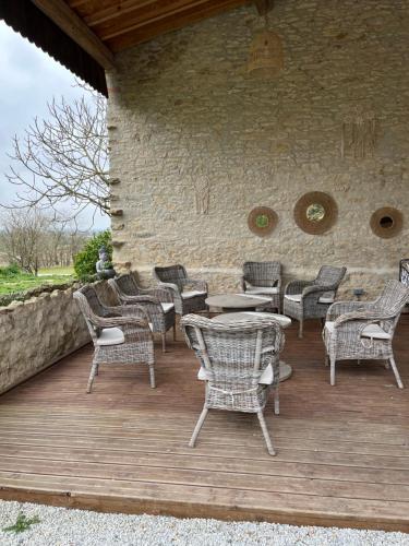 a group of chairs and tables on a wooden deck at Domaine Saladry in Villepinte