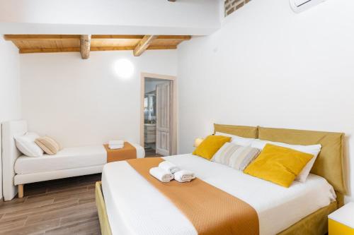 a bedroom with a large bed and a couch at Way to the sea - Home with garden & hot tub in Càbras