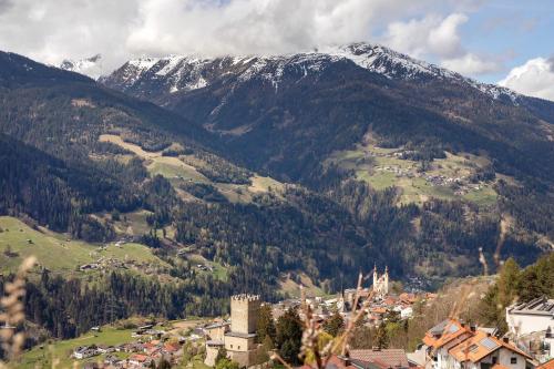 a town in a valley with a snow covered mountain at Apart Gabl in Fliess