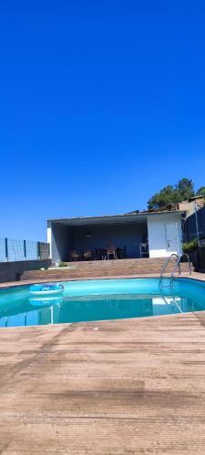 a swimming pool in front of a house at La Cigarrita Guest House - Douro Valley in Peso da Régua
